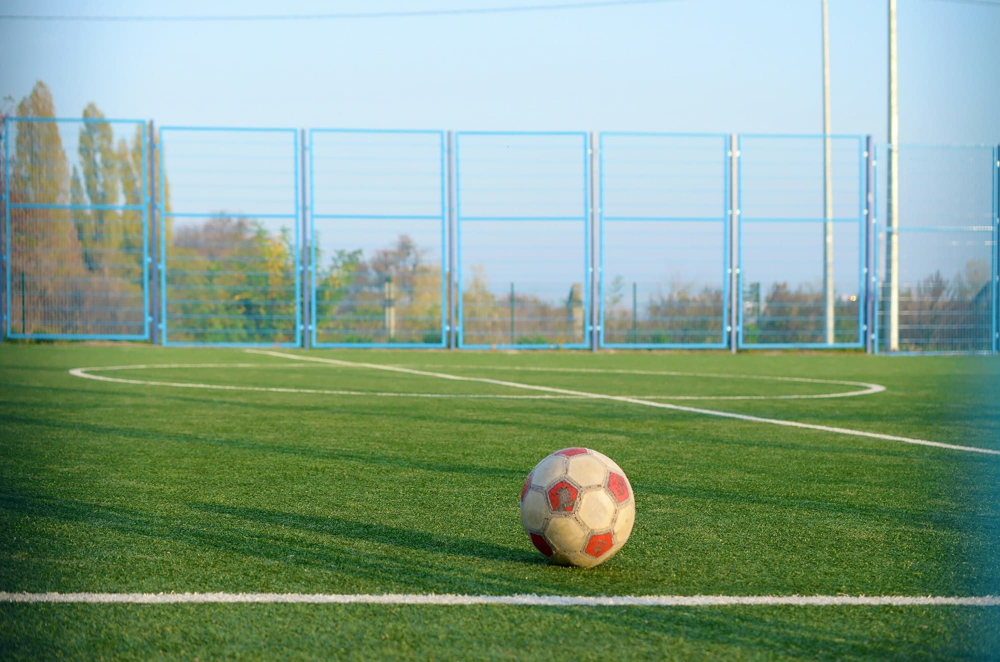 Classic soccer ball on football green grass field outdoor