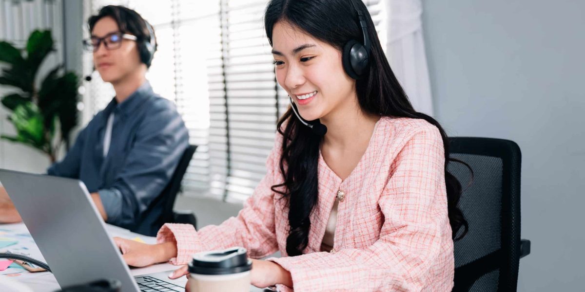 Customer service operator with headsets working at call centre